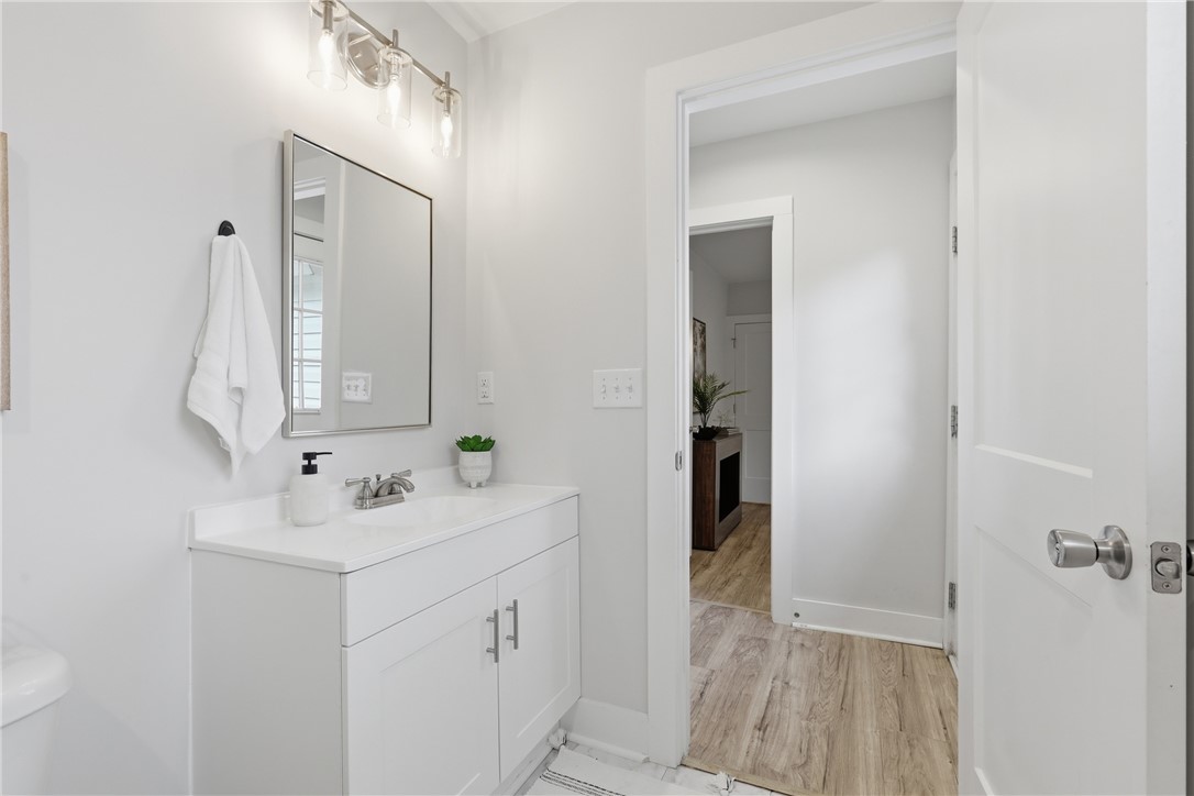 1 Brock Street Pelzer, SC 29669 - Photo 21 of 25 A well-lit bathroom vanity with ample counter space and a sleek mirror.