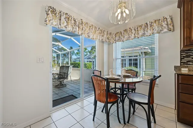 a view of a dining room with furniture and chandelier