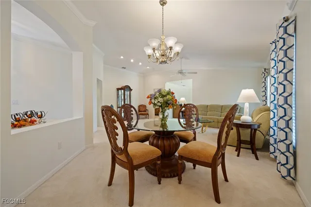 a view of a dining room with furniture and chandelier