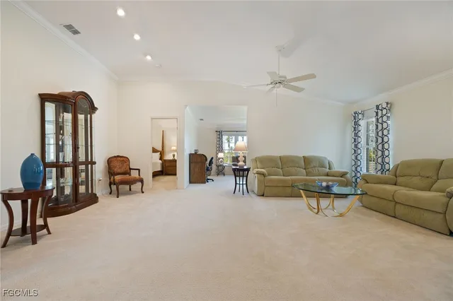 a living room with furniture a lamp and a chandelier