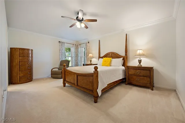 a bedroom with a bed a chandelier and dresser