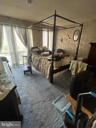 a bedroom with a bed and cupboard