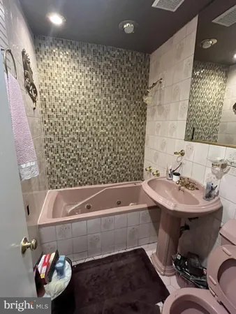 a white toilet sitting next to a shower curtain