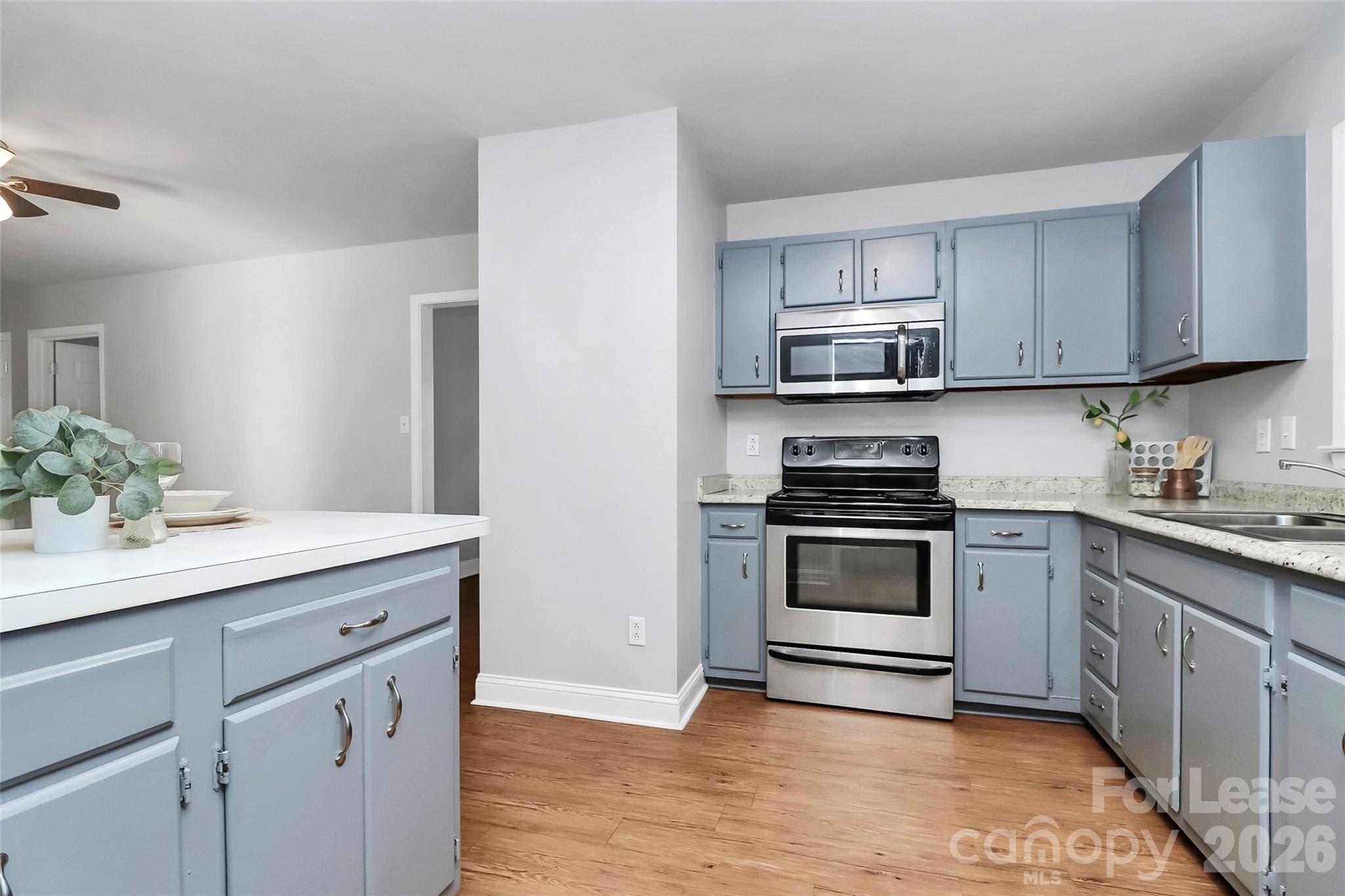 919 Pineborough Road Charlotte, NC 28212 - Photo 7 of 19 a kitchen with granite countertop a stove and a sink
