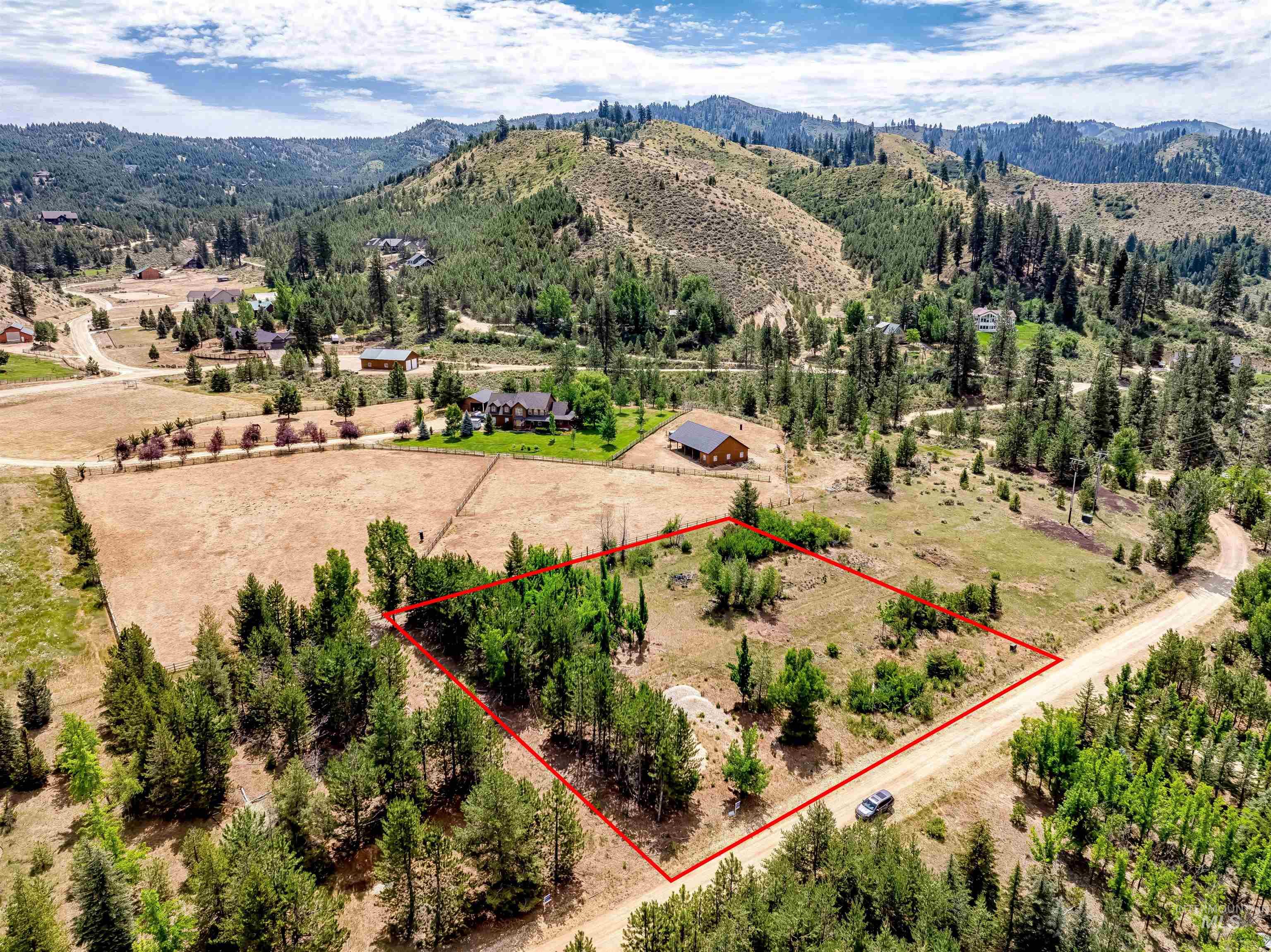Lot 16 Corral Flat Boise, ID 83716 - Photo 3 of 17 Aerial view of sparsely populated area with mountains and property parcel outlined