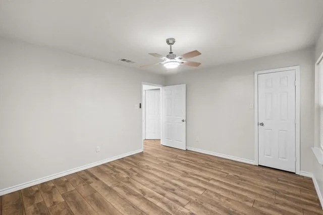 a view of an empty room with a ceiling fan