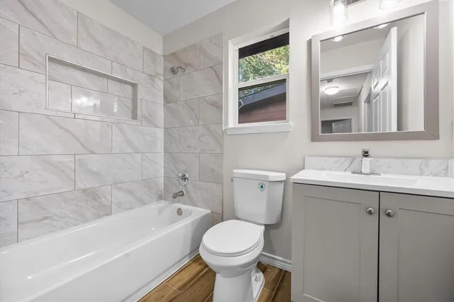 a bathroom with a sink toilet and bathtub
