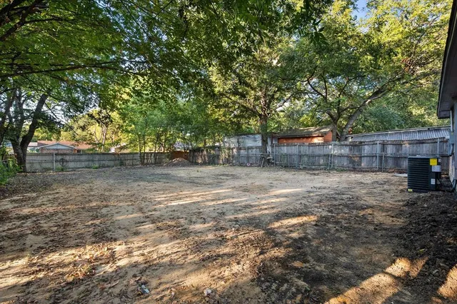 a view of a backyard with large trees