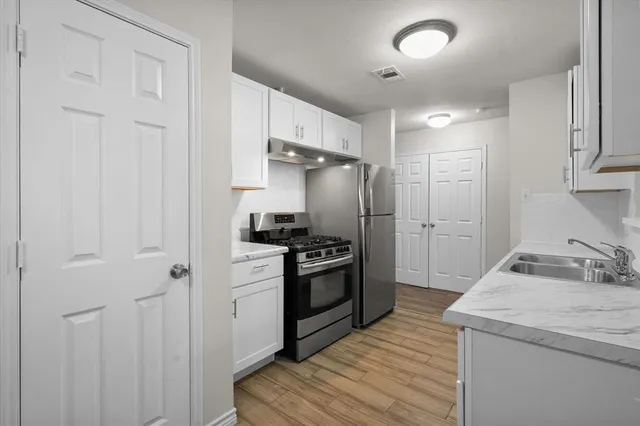 a kitchen with a sink stove and refrigerator
