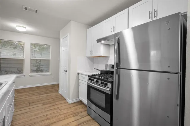 a kitchen with stainless steel appliances a refrigerator stove and sink