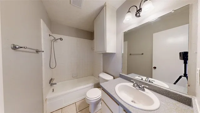a bathroom with a sink toilet tub and shower
