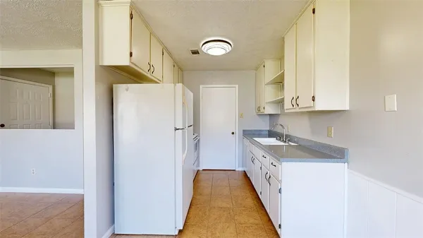 a kitchen with a refrigerator a sink and dishwasher