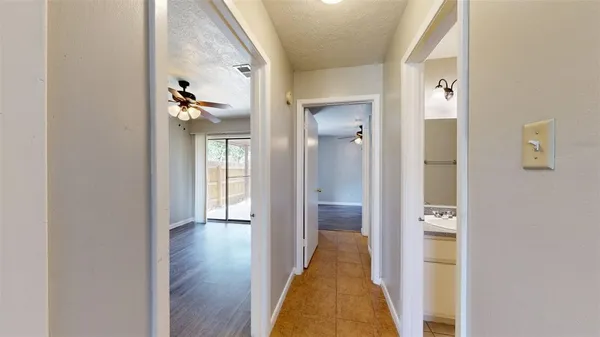 a view of a hallway with wooden floor and closet
