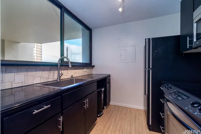 a kitchen with a sink stove and cabinets