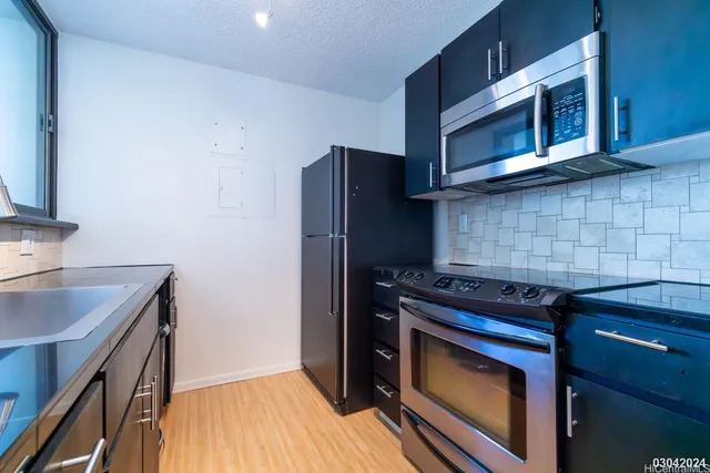 a kitchen with a stove and a microwave