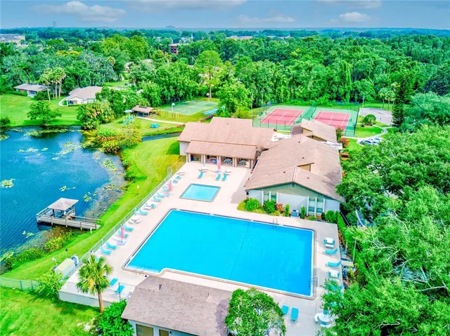 an aerial view of a house with a yard basket ball court and outdoor seating