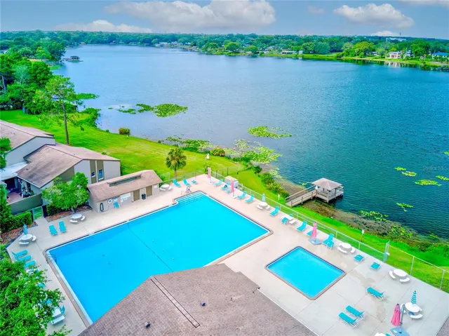 a green field with lots of trees in the background