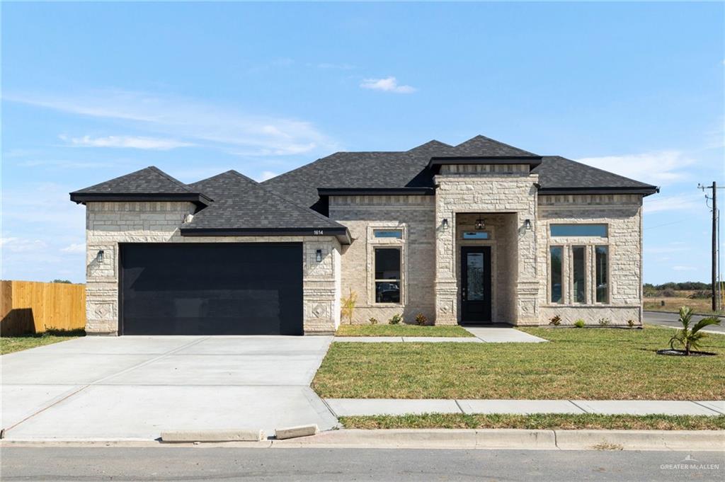 a front view of a house with a garden and plants