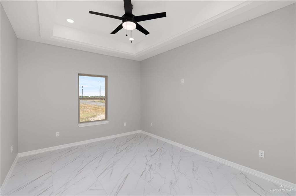 1614 Arden Street Mercedes, TX 78570 - Photo 11 of 17 an empty room with a window and a ceiling fan