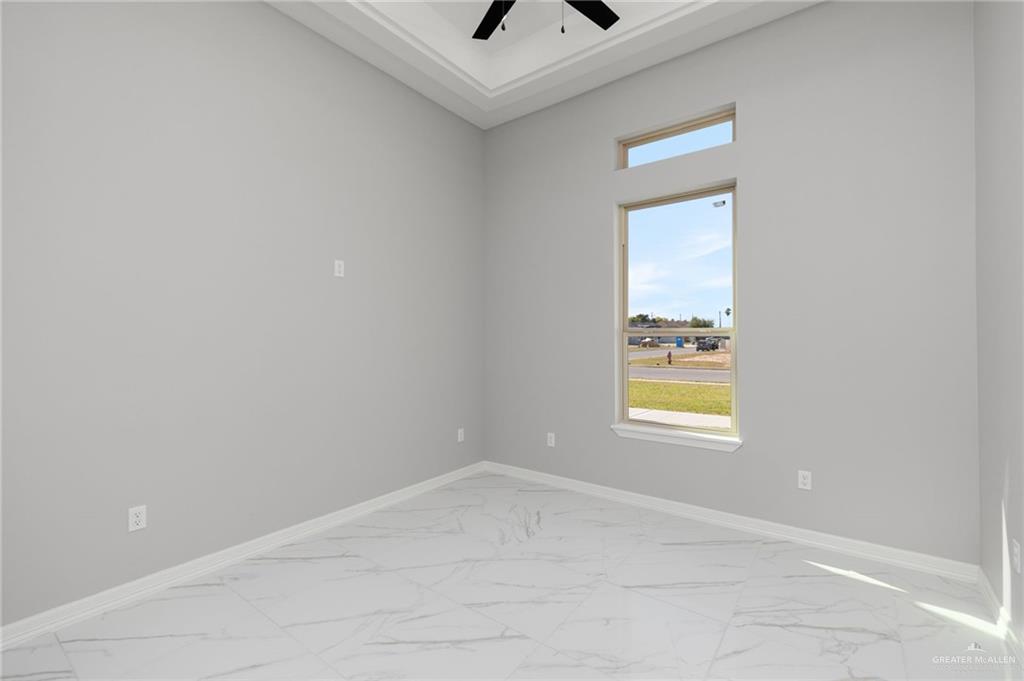 1614 Arden Street Mercedes, TX 78570 - Photo 13 of 17 an empty room with a window and a ceiling fan