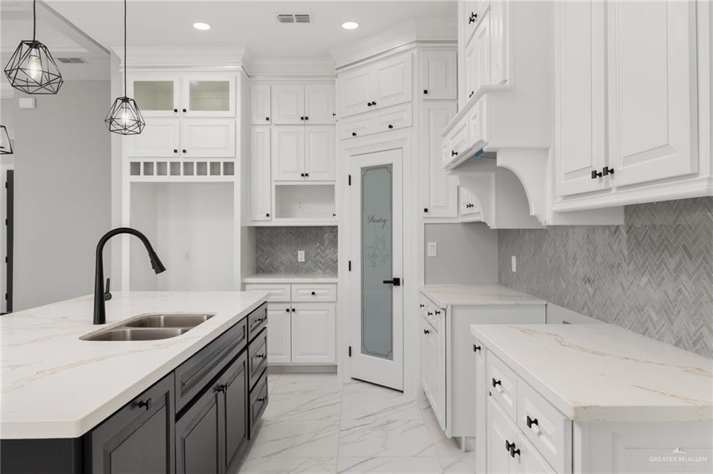 1614 Arden Street Mercedes, TX 78570 - Photo 5 of 17 a kitchen with stainless steel appliances a sink a stove and cabinets