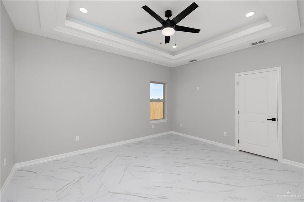 1614 Arden Street Mercedes, TX 78570 - Photo 7 of 17 an empty room with a window and a fan