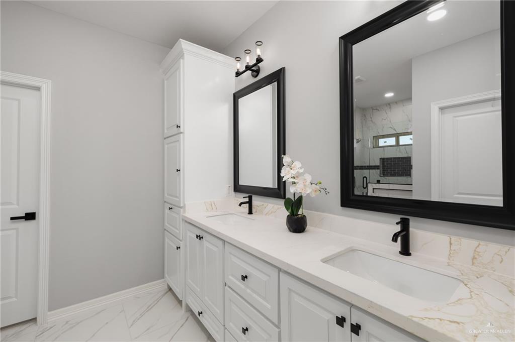 1614 Arden Street Mercedes, TX 78570 - Photo 8 of 17 a bathroom with double vanity sinks and a mirror