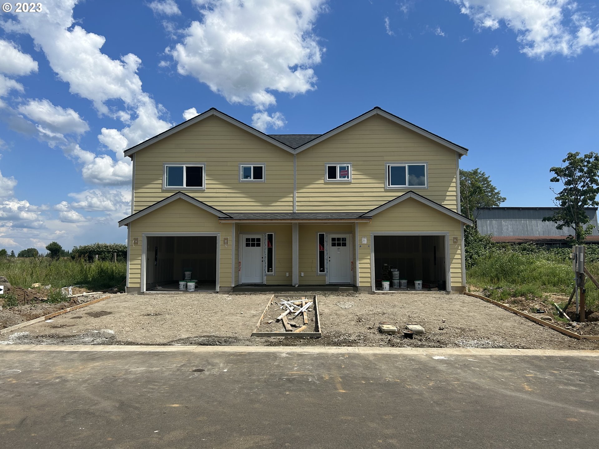1006 Peach Road Winlock, WA 98596 - Photo 1 of 15 a front view of a house with yard and garage