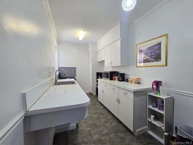 46 Grace Avenue, Unit 2J Great Neck, NY 11021 - Photo 13 of 20 a room with cabinets and window