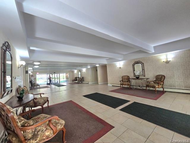 46 Grace Avenue, Unit 2J Great Neck, NY 11021 - Photo 4 of 20 a lobby with furniture and rug