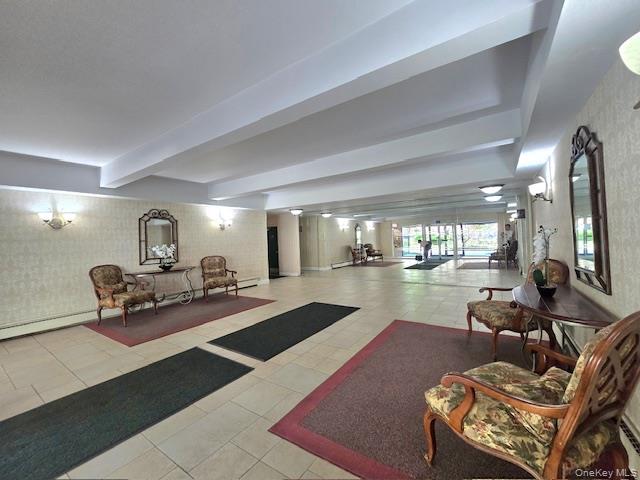 46 Grace Avenue, Unit 2J Great Neck, NY 11021 - Photo 5 of 20 a living room with furniture and a table