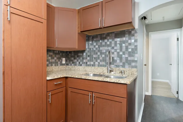 a kitchen with a sink and cabinets