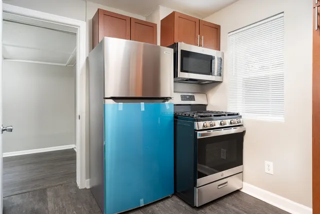 a kitchen with stainless steel appliances a stove a microwave and a refrigerator