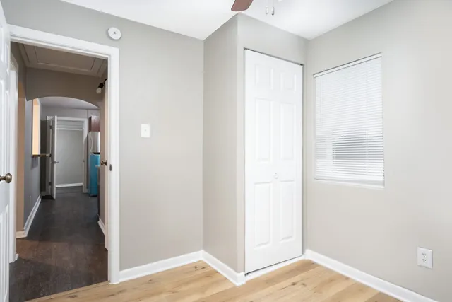 a view of a room with wooden floor and a bathroom
