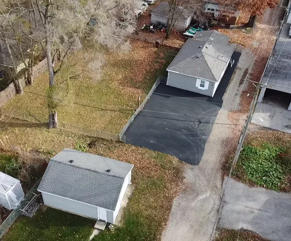 an aerial view of a residential houses with outdoor space
