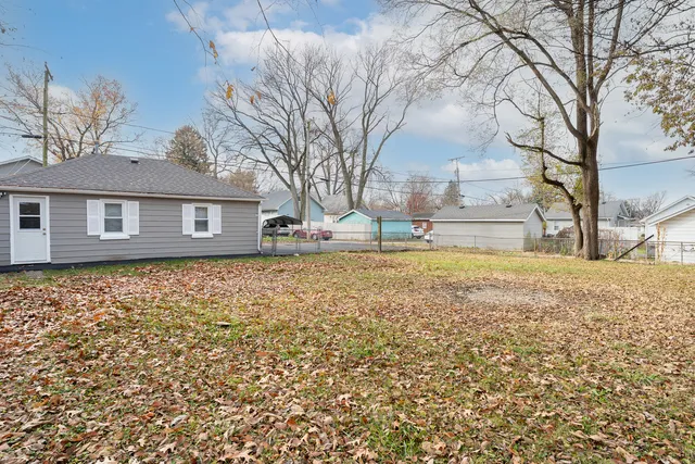 a view of a house with a yard covered with snow
