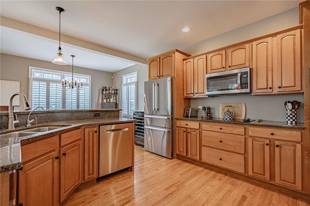 6000 Pond View Terrace Bath, PA 18014 - Photo 22 of 69 A chef's kitchen boasts hardwood flooring, a double basin sink, and ample cabinet storage.