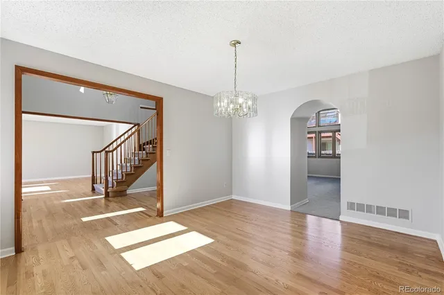 a kitchen with a sink wooden floor and stainless steel appliances