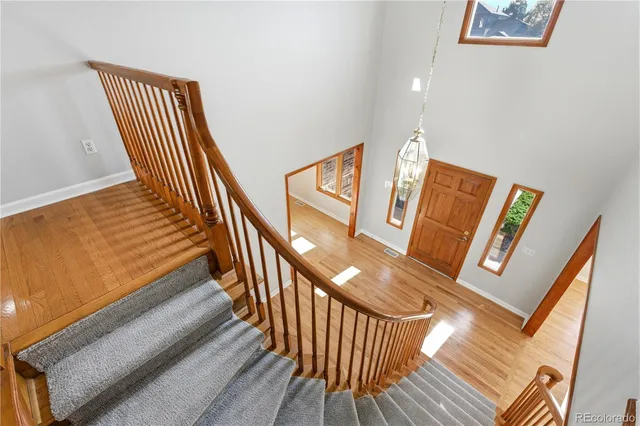 a kitchen with stainless steel appliances granite countertop a sink a stove a refrigerator and cabinets