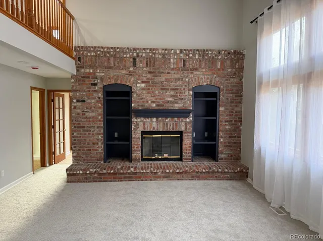 a kitchen with cabinets stainless steel appliances and wooden floor