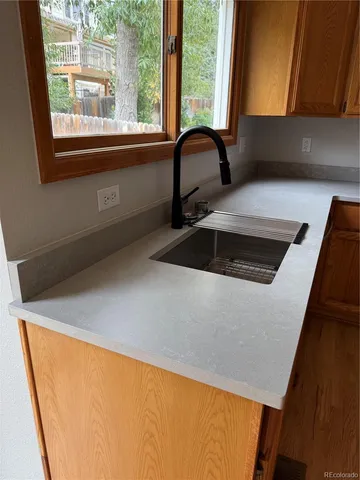 a spacious bathroom with a granite countertop sink a large mirror and a bathtub