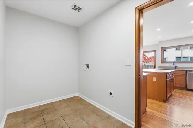 an empty room with wooden floor and window
