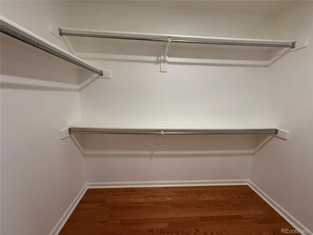 an empty room with wooden floor and window