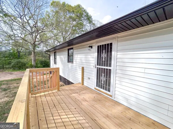 a view of backyard with a deck