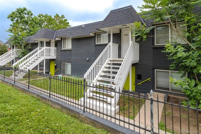a view of a house with wooden fence