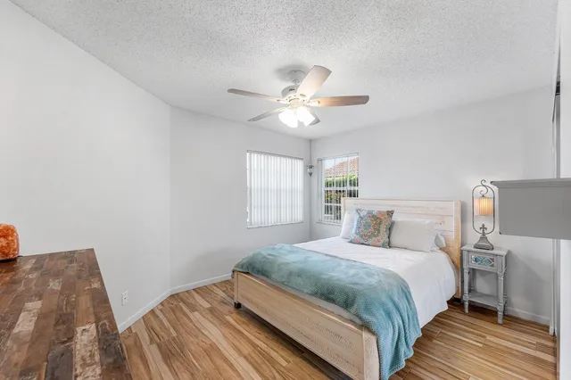a bedroom with a bed and a ceiling fan