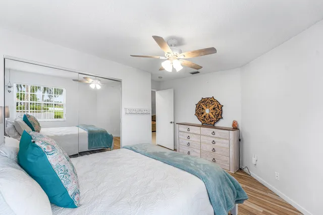 a bedroom with a bed dresser and a window