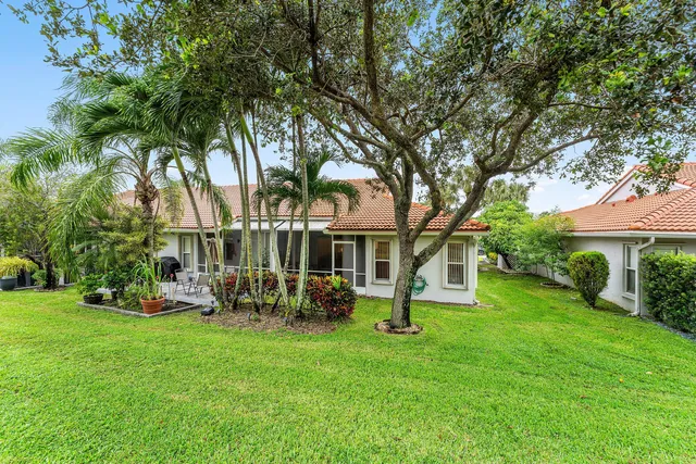 a view of a house with a backyard