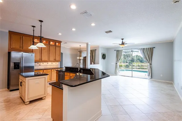 a kitchen with sink refrigerator and microwave