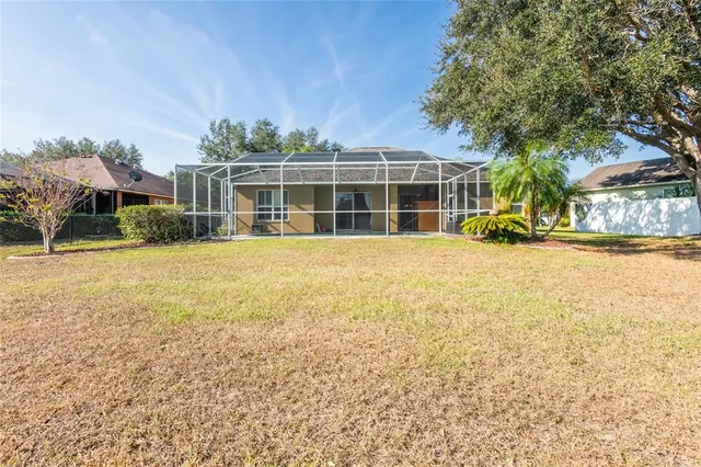 a view of a house with a backyard and balcony